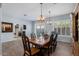 Formal dining area features a large dining table with wooden chairs and a decorative chandelier at 1904 E Grand Canyon Dr, Chandler, AZ 85249