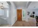 Inviting entryway with a solid wood door, neutral paint, tile flooring, and arched doorways at 1904 E Grand Canyon Dr, Chandler, AZ 85249
