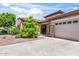 Well-maintained home featuring a two car garage, desert landscaping, and stacked stone accents at 1904 E Grand Canyon Dr, Chandler, AZ 85249