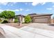 Well-manicured front yard and landscaping, this property features a neutral color scheme and a three-car garage at 1904 E Grand Canyon Dr, Chandler, AZ 85249