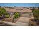 Well-maintained single-Gathering home with a large driveway, desert landscaping, and two car garage at 1904 E Grand Canyon Dr, Chandler, AZ 85249