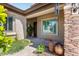 Charming front porch with stone accents, shuttered windows, and decorative plants create a welcoming entrance at 1904 E Grand Canyon Dr, Chandler, AZ 85249