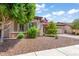 Charming single-story home featuring stone accents, mature trees, and easy to care for desert landscaping at 1904 E Grand Canyon Dr, Chandler, AZ 85249