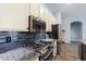 Modern kitchen features stainless steel appliances, granite countertops, and stylish backsplash at 1904 E Grand Canyon Dr, Chandler, AZ 85249