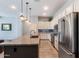 Updated kitchen with a granite island, stainless steel appliances, white cabinetry, and wood-look tile flooring at 1904 E Grand Canyon Dr, Chandler, AZ 85249