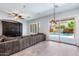 Bright living room boasts a large sectional sofa and a view of the backyard pool at 1904 E Grand Canyon Dr, Chandler, AZ 85249