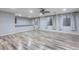 Bright, spacious living room with wood-look floors, neutral walls, and large windows with modern window coverings at 1904 E Grand Canyon Dr, Chandler, AZ 85249