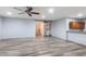 Large living room showcasing attractive wood-look floors, barn door accent, and access to staircase at 1904 E Grand Canyon Dr, Chandler, AZ 85249