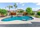 Backyard oasis featuring a sparkling pool, mature palm trees, and privacy fencing for outdoor enjoyment at 1904 E Grand Canyon Dr, Chandler, AZ 85249