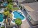 A private backyard featuring desert landscaping, a freeform pool and spa, and covered patio at 1904 E Grand Canyon Dr, Chandler, AZ 85249