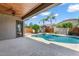 Backyard pool area with lush landscaping, ample deck space, and a covered patio, ideal for outdoor living at 1904 E Grand Canyon Dr, Chandler, AZ 85249