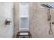 Elegant shower features marble tiling, a rain shower head and bench seating at 1904 E Grand Canyon Dr, Chandler, AZ 85249