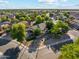 The exterior features drought-resistant landscaping, green turf, and mature shade trees at 1924 S Rome St, Gilbert, AZ 85295