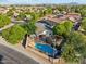 Enjoy this stunning aerial view of the home with a private pool and lush, mature landscaping at 1924 S Rome St, Gilbert, AZ 85295
