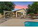 Inviting backyard featuring a refreshing pool, fire pit, and covered patio seating area at 1924 S Rome St, Gilbert, AZ 85295