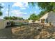 A spacious backyard with a pool is set among beautiful trees and desert landscaping at 1924 S Rome St, Gilbert, AZ 85295
