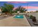 Sparkling pool area with desert landscaping, mature trees, and an inviting firepit for outdoor enjoyment at 1924 S Rome St, Gilbert, AZ 85295
