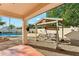 Inviting backyard featuring a covered patio, swing and seating area, with a pool for relaxation and entertainment at 1924 S Rome St, Gilbert, AZ 85295