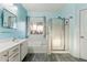 Bright bathroom featuring a tub with a glass shower, white cabinets, and a fresh, clean aesthetic at 1924 S Rome St, Gilbert, AZ 85295
