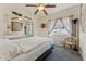 Bright bedroom with a large bed, mirrored closet doors, neutral decor, and ample natural light at 1924 S Rome St, Gilbert, AZ 85295