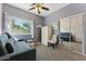 Comfortable bedroom with a sofa, neutral decor, ceiling fan and built in mirrored closet at 1924 S Rome St, Gilbert, AZ 85295