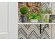 Close up on potted plants and black and white design wallpaper on a shelf for home decor at 1924 S Rome St, Gilbert, AZ 85295