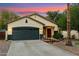 Charming home with a two-car garage, desert landscaping, and a welcoming front entrance at 1924 S Rome St, Gilbert, AZ 85295