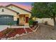 A well-maintained home with desert landscaping, an arched entryway, and a two-car garage at 1924 S Rome St, Gilbert, AZ 85295