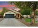 Charming single-story home with a well-manicured lawn and a two-car garage at 1924 S Rome St, Gilbert, AZ 85295