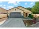 Well maintained home with a two car garage, long driveway and desert landscaping at 1924 S Rome St, Gilbert, AZ 85295