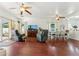 Open-concept living room with hardwood floors, neutral paint, and abundant natural light at 1924 S Rome St, Gilbert, AZ 85295