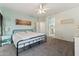 Comfortable bedroom with a ceiling fan, natural light, and access to an en-suite bathroom at 1924 S Rome St, Gilbert, AZ 85295