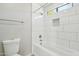 Bright bathroom features a modern shower/tub with white tiling, recessed lighting and updated fixtures at 20149 N 92Nd Ave, Peoria, AZ 85382