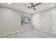 Neutral bedroom featuring a ceiling fan, a window, and a door for easy access at 20149 N 92Nd Ave, Peoria, AZ 85382