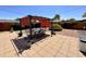 Backyard featuring a large patio area, shade canopies, and manicured landscaping at 2537 E Hazelwood St, Phoenix, AZ 85016