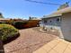 Backyard view showcasing a fountain feature, gravel landscaping, and partial exterior of the home at 2537 E Hazelwood St, Phoenix, AZ 85016