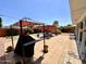 Backyard with a large patio area, shade canopies, potted plants, and greenery at 2537 E Hazelwood St, Phoenix, AZ 85016