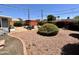 Secluded backyard featuring decorative rock, lush landscaping, and a cozy outdoor seating area at 2537 E Hazelwood St, Phoenix, AZ 85016