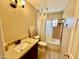 Bathroom featuring wood-look tile, dark vanity, and tub-shower combo with a window at 2537 E Hazelwood St, Phoenix, AZ 85016