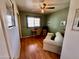 Bedroom with hardwood floors, a ceiling fan, sofa, and desk under a window at 2537 E Hazelwood St, Phoenix, AZ 85016