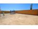 Open backyard featuring a trampoline, surrounded by a block wall and desert landscaping at 25951 W Piute Ave, Buckeye, AZ 85396