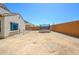 Wide backyard with a trampoline, chain link fence, and block wall, offering space for leisure at 25951 W Piute Ave, Buckeye, AZ 85396
