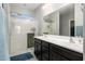 Bright bathroom with double sink vanity and a large glass enclosed shower at 25951 W Piute Ave, Buckeye, AZ 85396