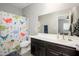 Well-lit bathroom with a dinosaur-themed shower curtain, perfect for a  at 25951 W Piute Ave, Buckeye, AZ 85396