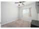 Bright, neutral bedroom featuring a ceiling fan and a window at 25951 W Piute Ave, Buckeye, AZ 85396