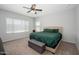 Inviting bedroom with plush carpet, ceiling fan, and storage bench at 25951 W Piute Ave, Buckeye, AZ 85396