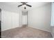 Spacious bedroom with carpet flooring, a ceiling fan, and a large closet at 25951 W Piute Ave, Buckeye, AZ 85396