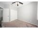 Neutral bedroom with carpet flooring, a ceiling fan, and a closet at 25951 W Piute Ave, Buckeye, AZ 85396
