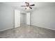 Empty bedroom with tile floors, ceiling fan and an open door entry at 25951 W Piute Ave, Buckeye, AZ 85396