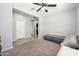 Cozy bedroom featuring carpeted floors and a comfortable seating area at 25951 W Piute Ave, Buckeye, AZ 85396